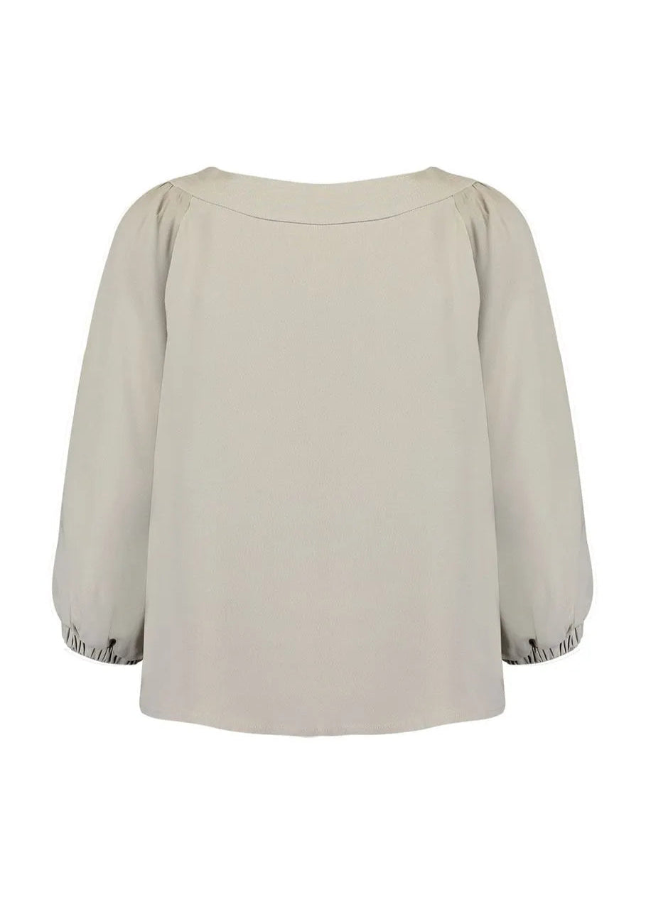 Beige blouse with ruffled sleeves on a white background