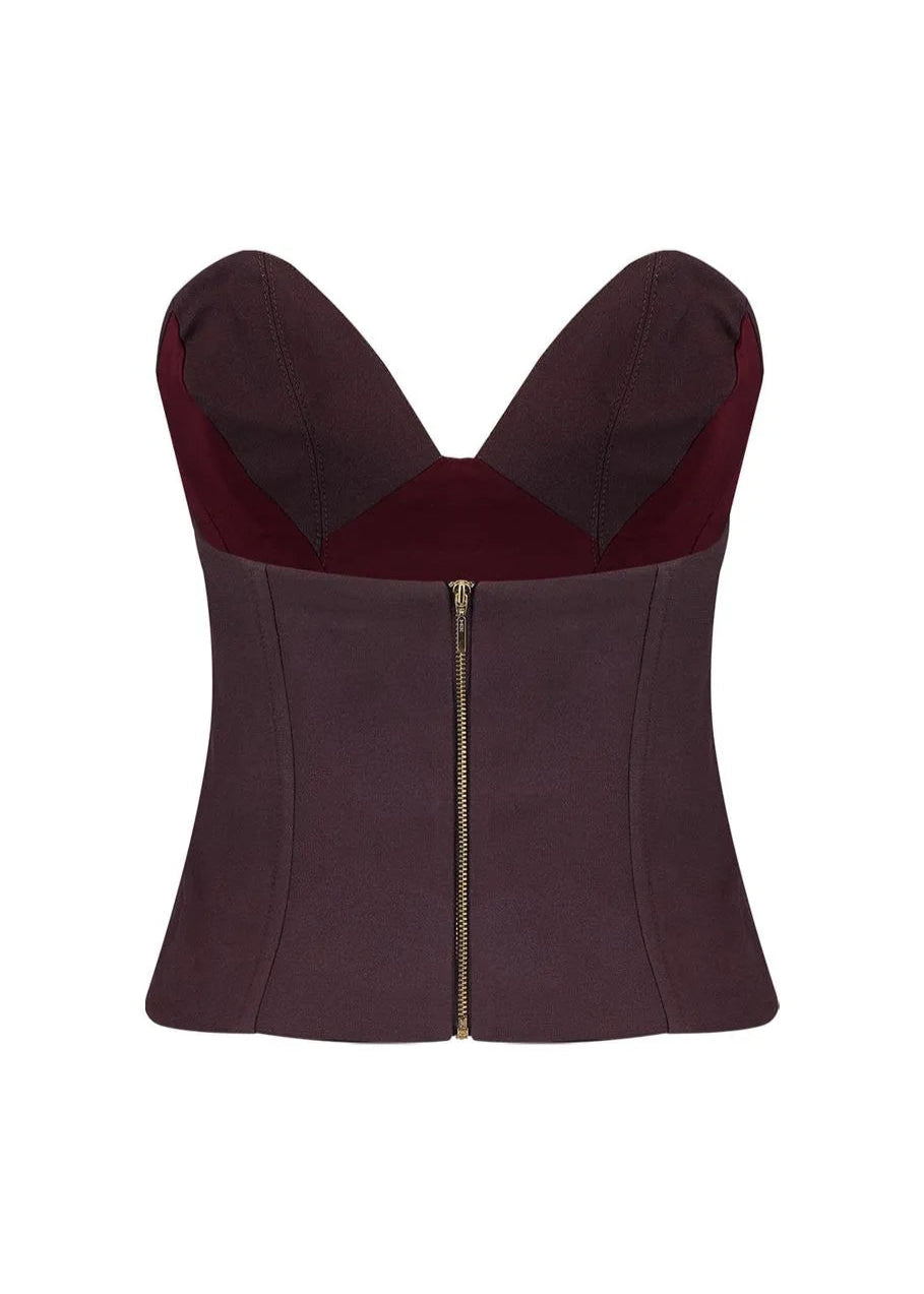 Burgundy corset top with a zipper on a white background