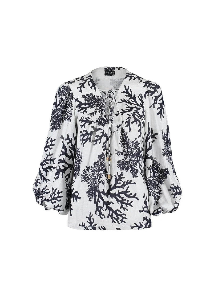 White blouse with black floral pattern on a white background