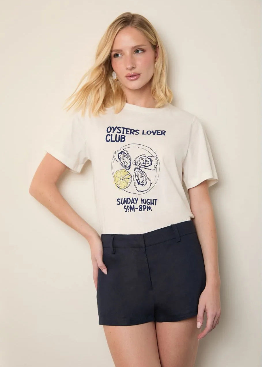 Woman wearing a 'Oysters Lover Club' t-shirt with graphic design on a plain background