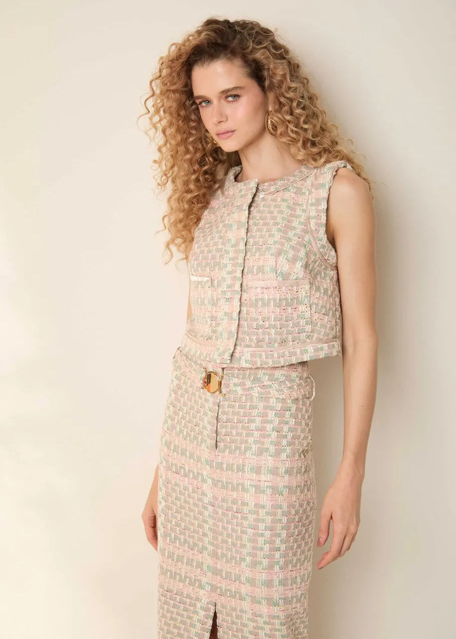 Woman wearing a patterned outfit against a plain background