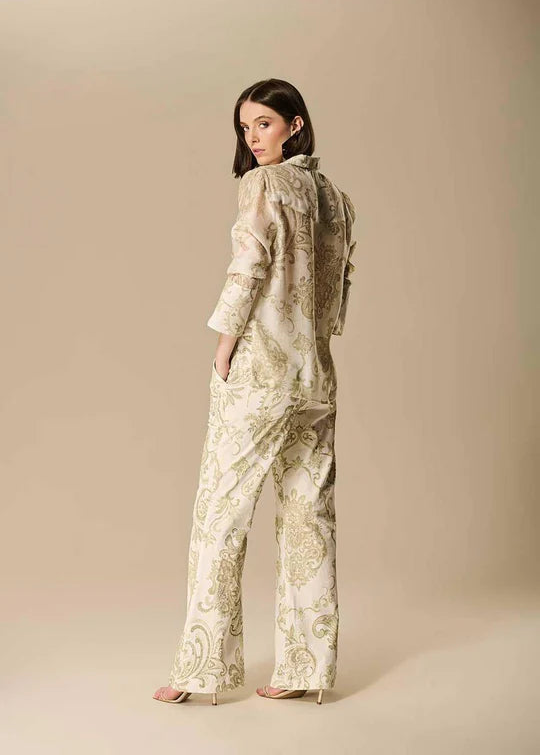 Woman wearing a patterned outfit on a beige background