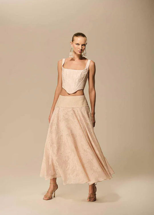 Woman wearing a beige dress with a plain background