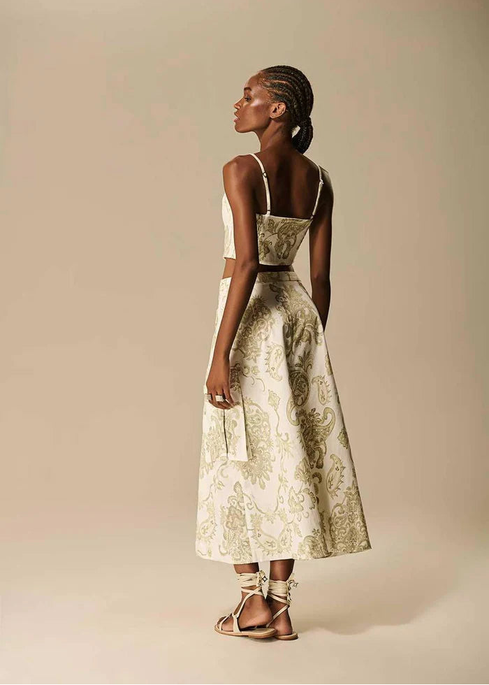 Woman wearing a floral dress against a beige background