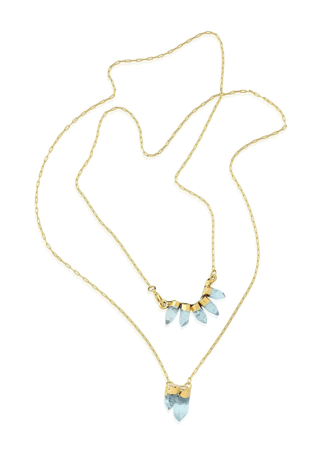 Gold necklace with light blue gemstones on a white background
