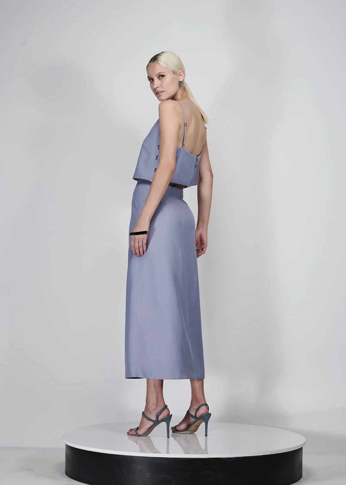 Woman wearing a light purple dress with a white background