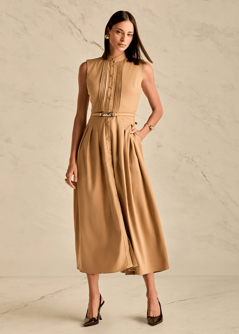 Woman wearing a beige dress against a neutral background