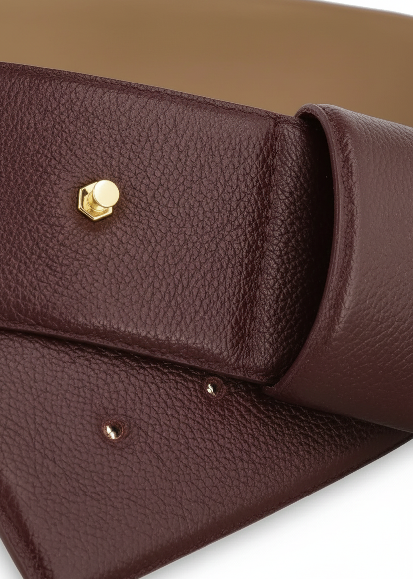 Close-up of a brown pebbled leather clutch or wallet with a gold-tone hexagonal stud closure, shown on a white background.