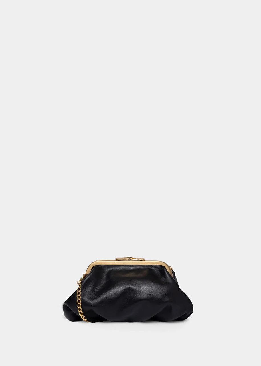 Black handbag with gold chain on a light gray background