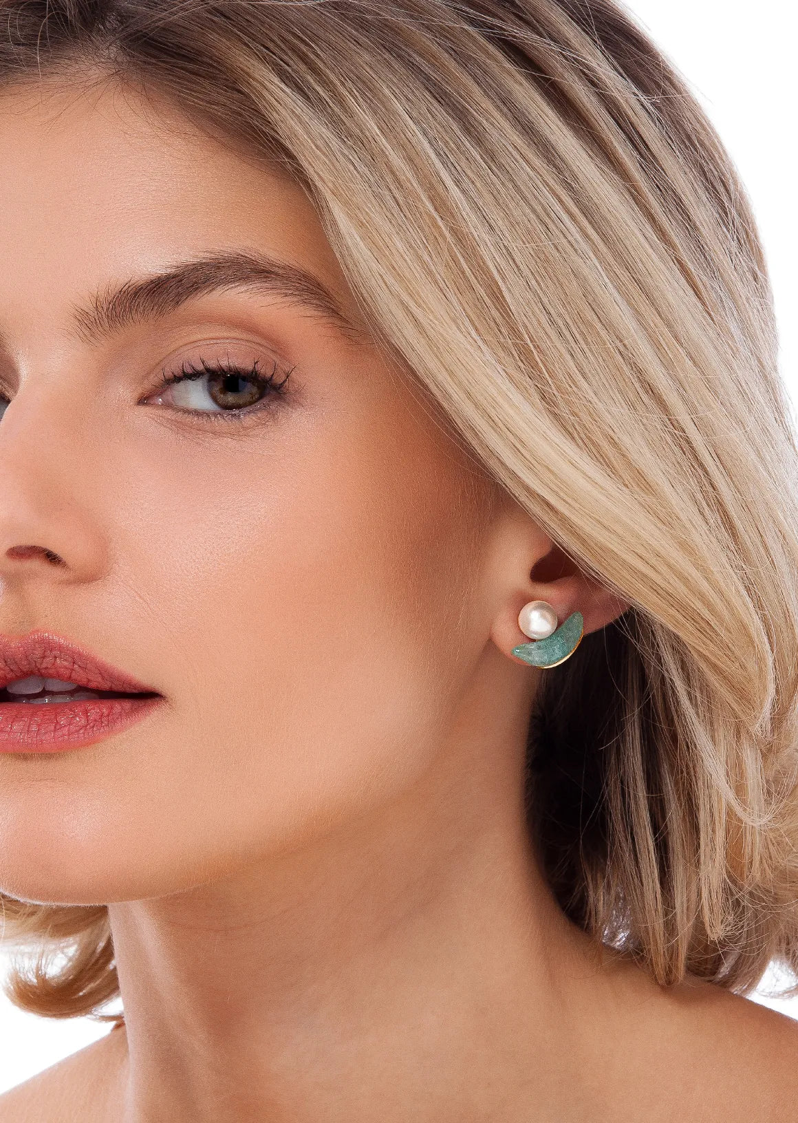 Close-up of a woman wearing earrings with a white background