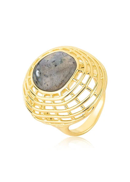 A gold ring with a large oval gray stone featuring natural speckles, set in a textured, openwork basket-like design on a white background.