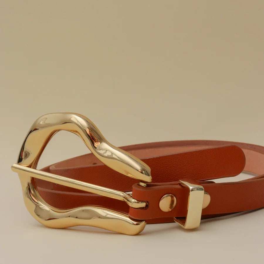 Brown leather belt with a gold buckle on a beige background