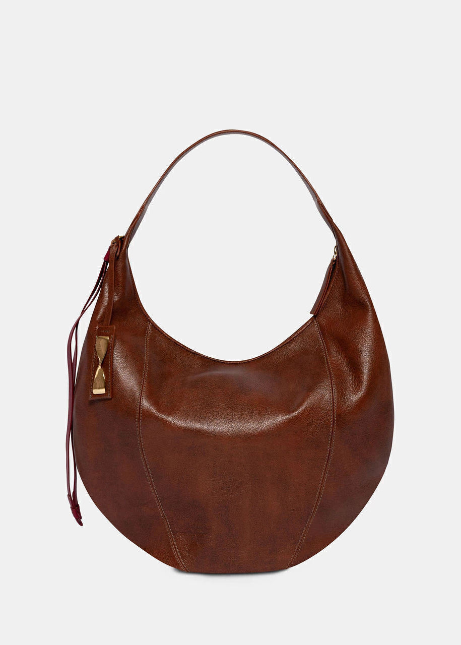 Brown leather handbag on a light gray background