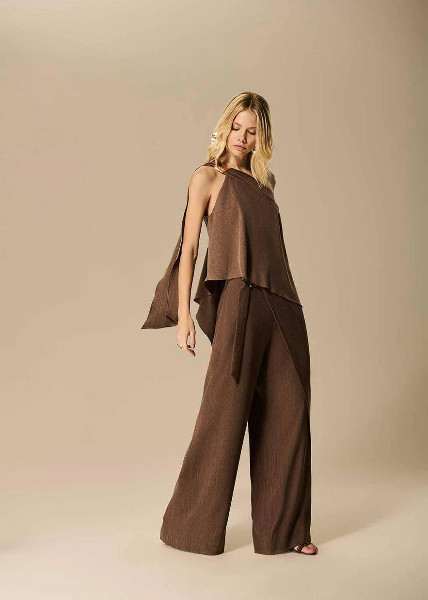 Woman wearing a brown outfit on a beige background