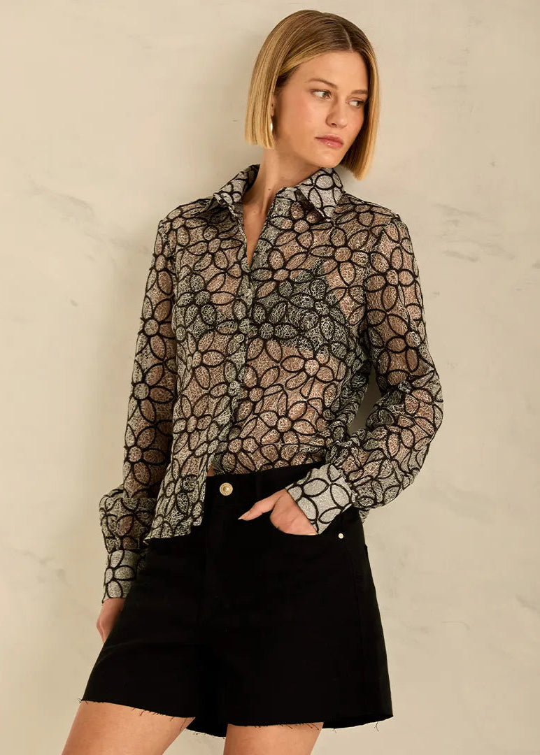 Woman wearing a sheer black floral shirt