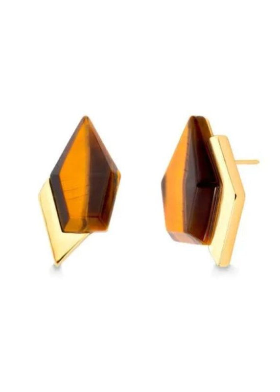 Gold and amber colored geometric earrings on a white background