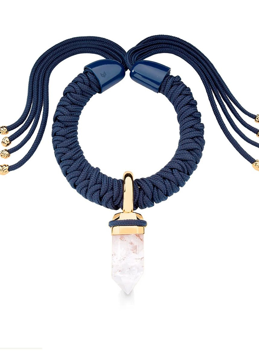 Navy blue braided necklace with a gold and rose quartz pendant on a white background