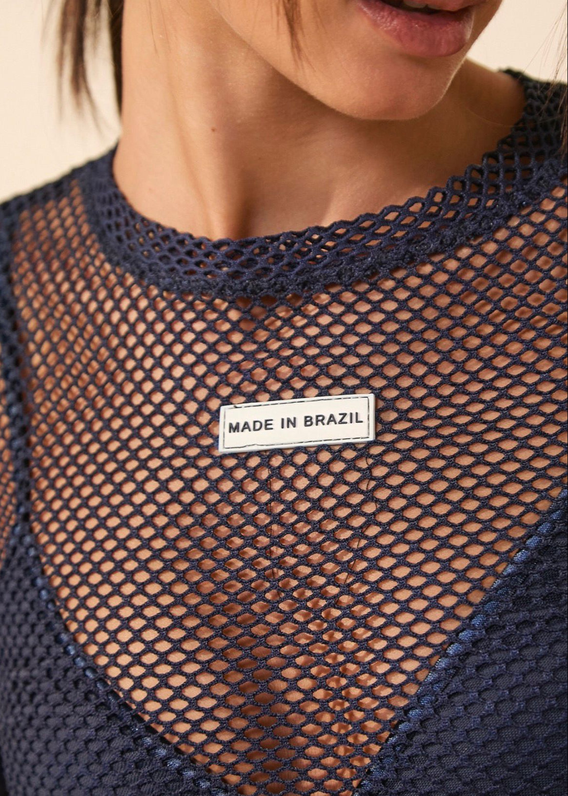Navy fishnet top with 'Made in Brazil' label on a neutral background