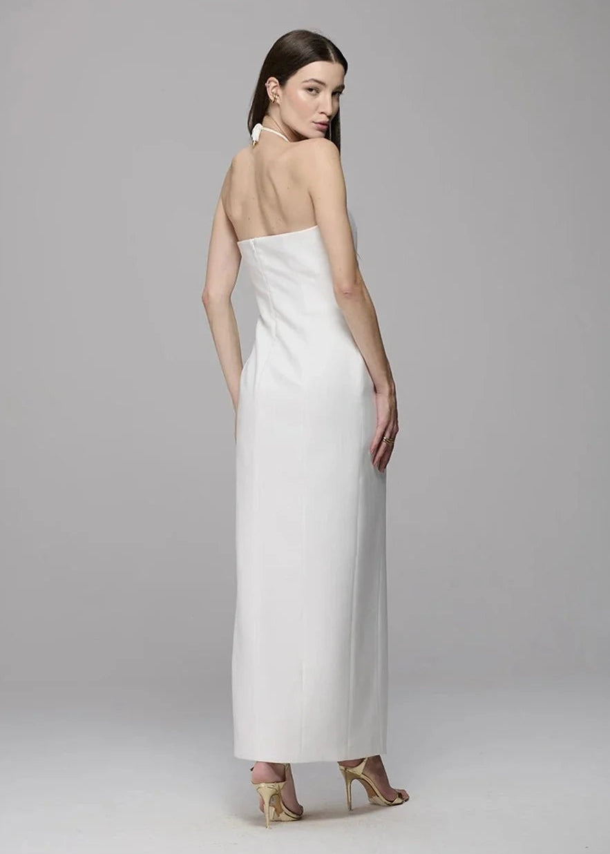 Woman wearing a white strapless gown on a gray background