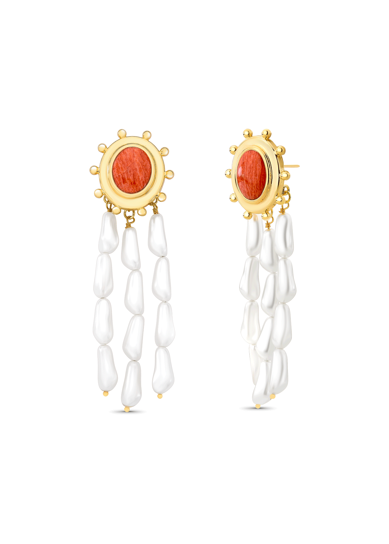 Pair of earrings with gold accents, red stones, and white beads on a white background