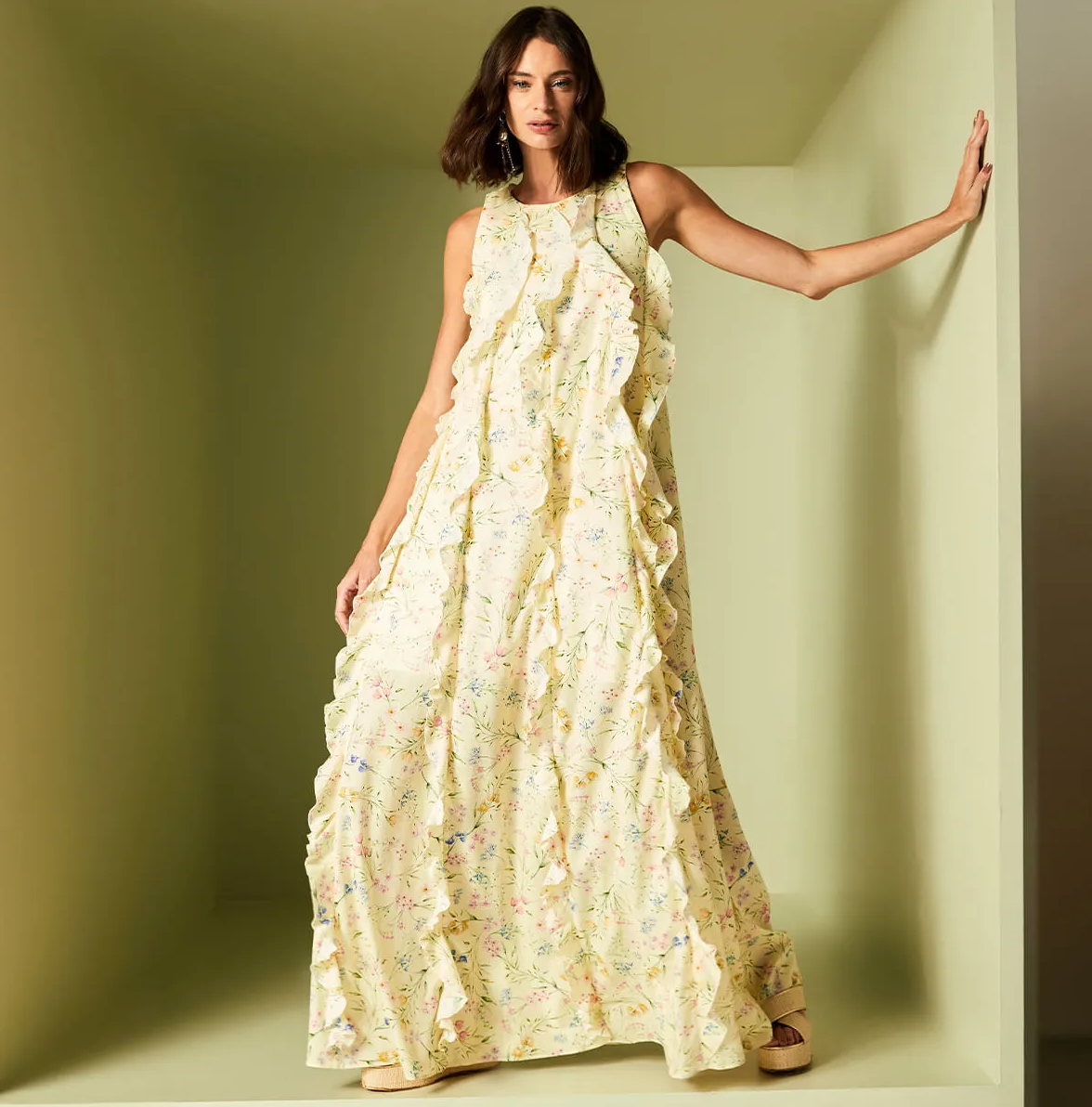 Woman wearing a floral dress against a plain background