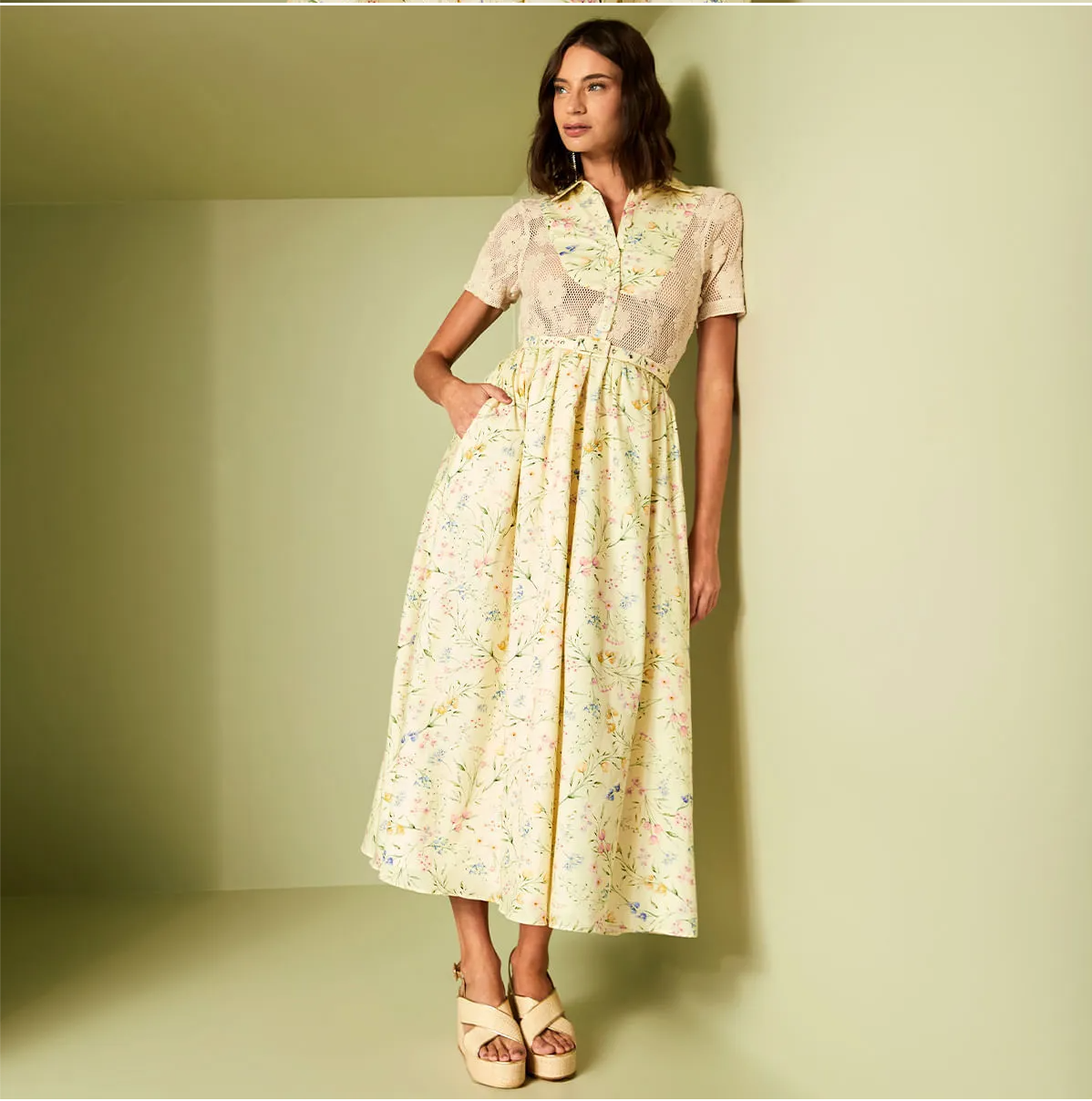 Woman wearing a floral dress against a plain background