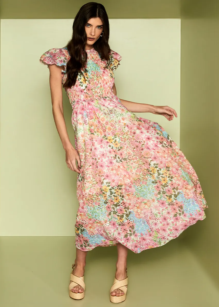 Woman wearing a floral dress against a light green background