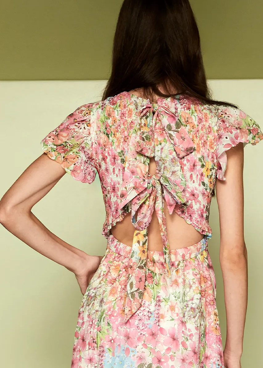 Woman wearing a floral dress with a green background