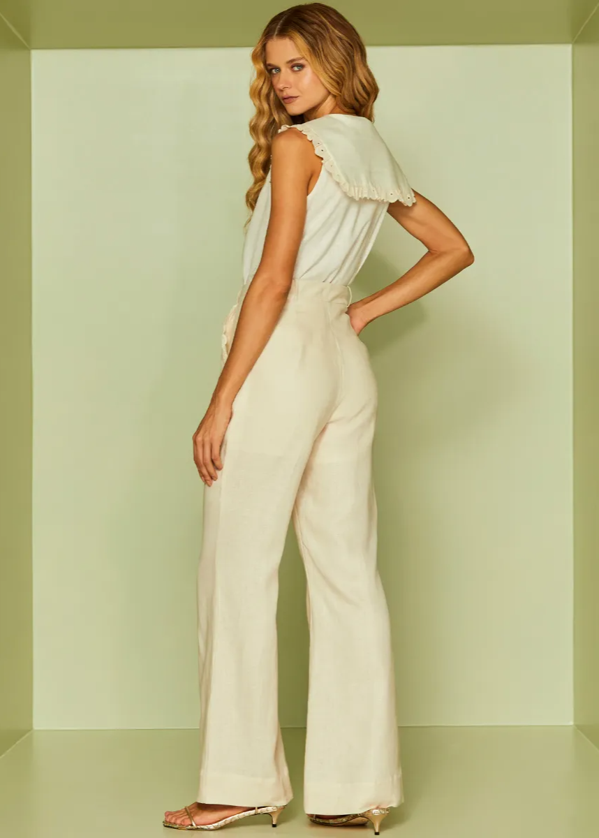 Woman wearing a white outfit against a light green background