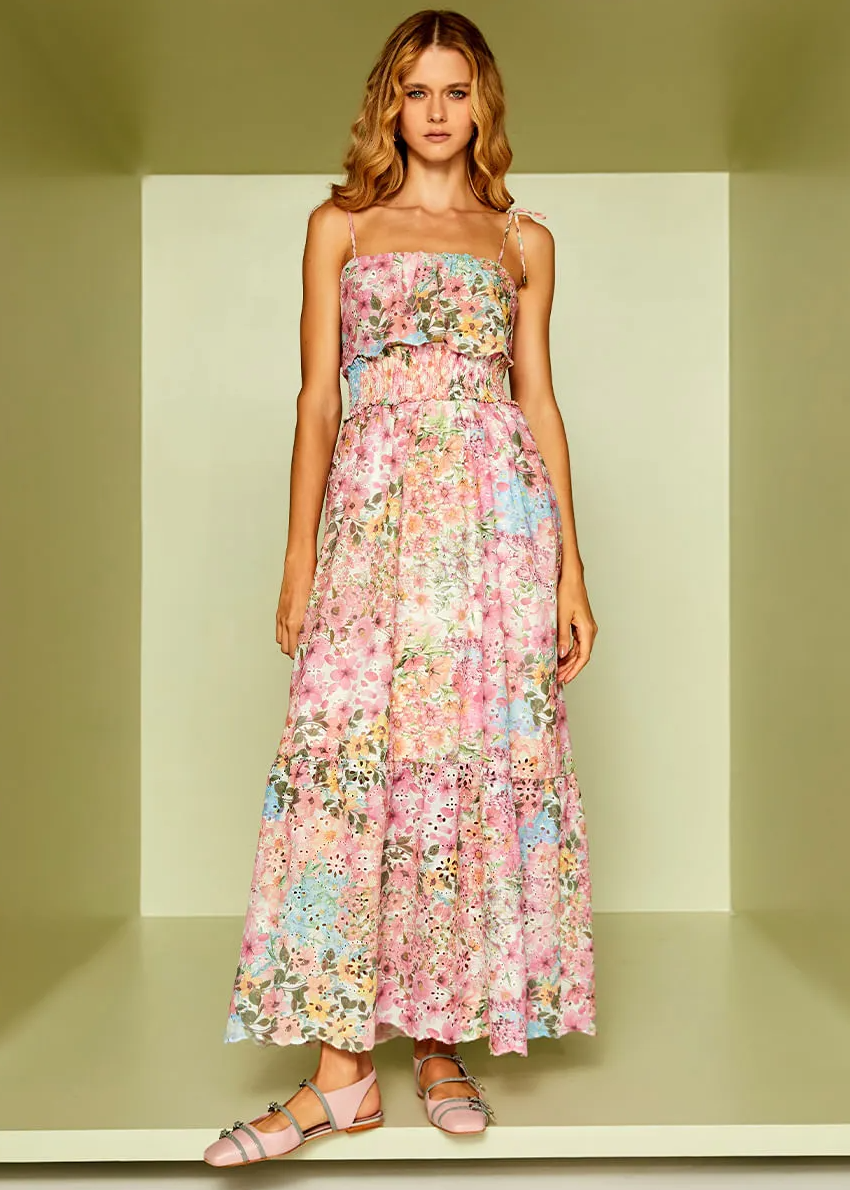 Woman wearing a floral dress in a minimalistic setting