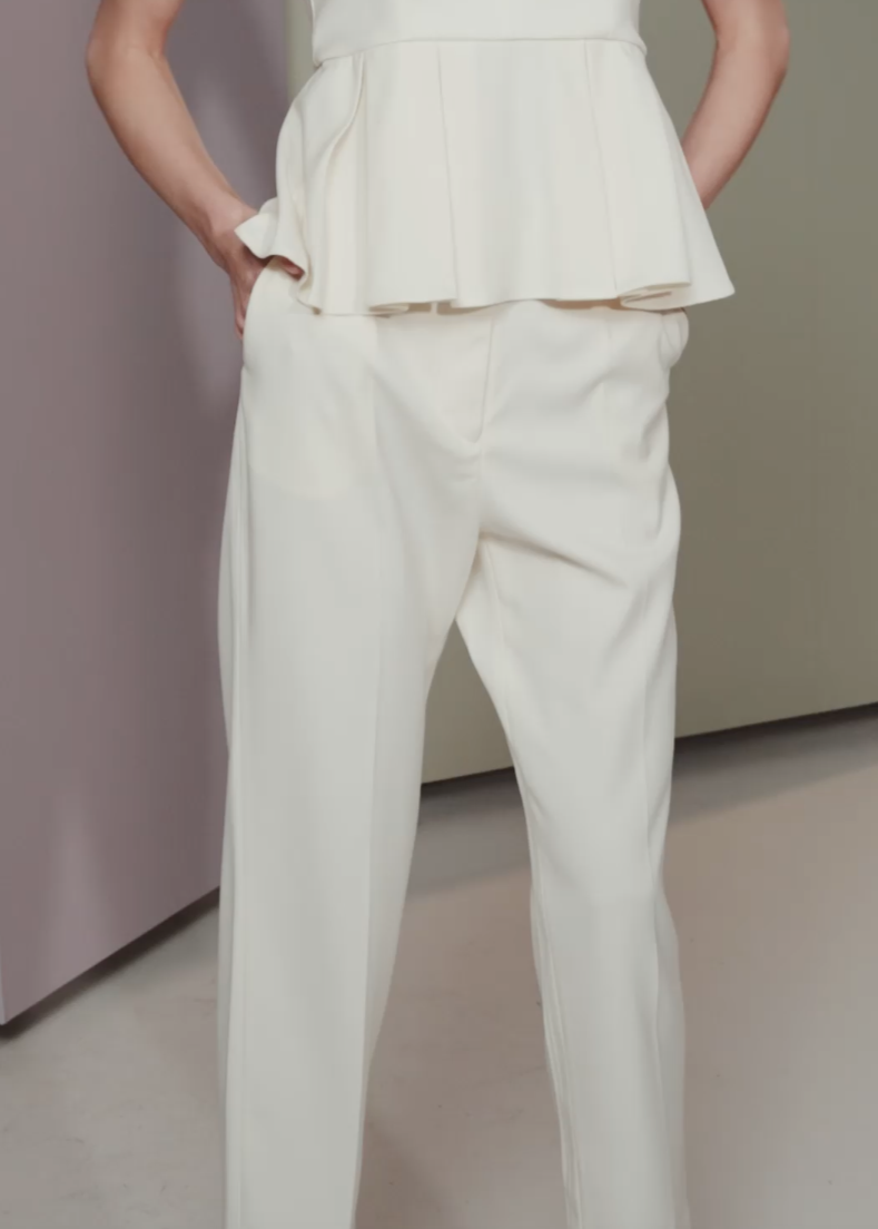 Person wearing a white outfit with a blurred background