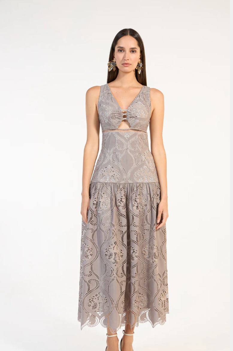 Woman wearing a gray lace dress on a white background