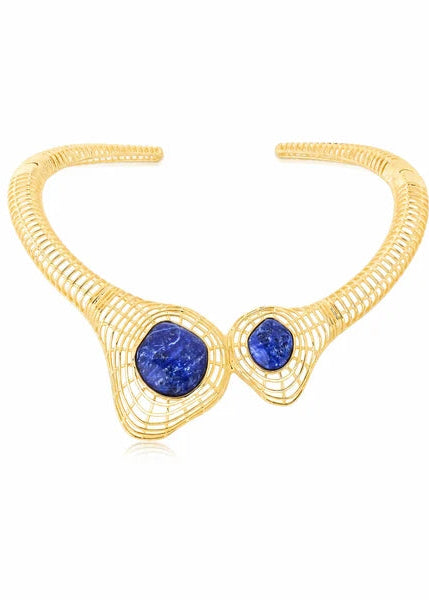 Gold wireframe cuff bracelet with two large oval blue lapis lazuli stones and one smaller round blue stone, set against a plain white background.