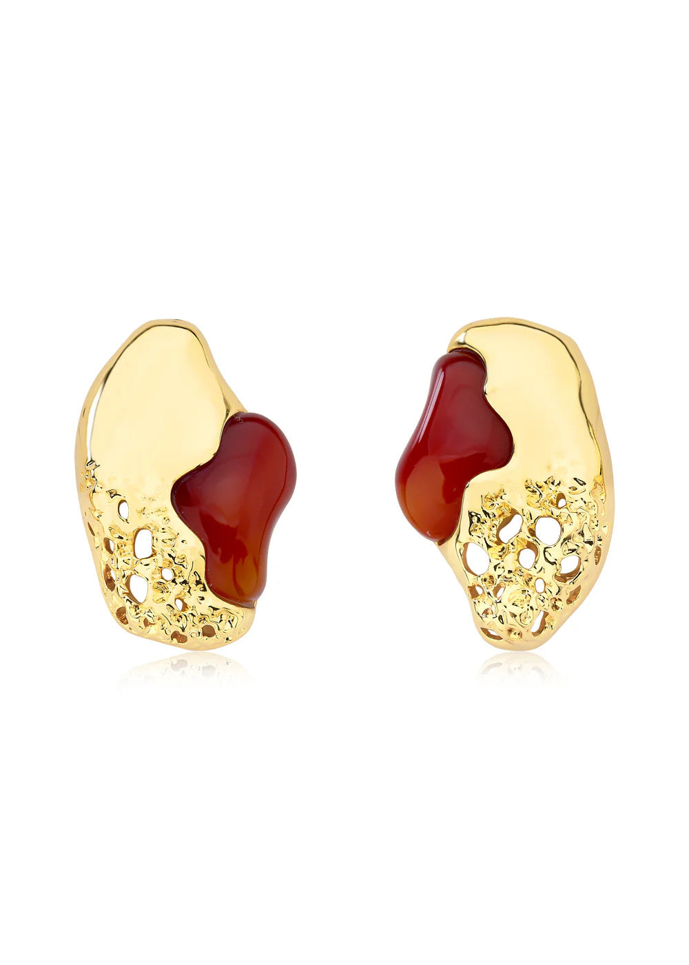 Gold earrings with red stone on a white background