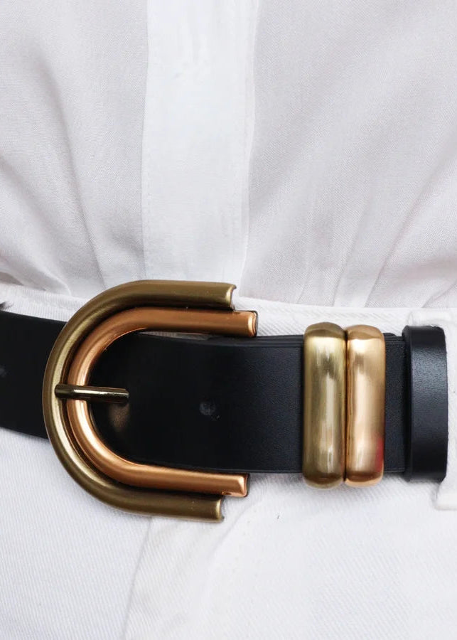 Black belt with a gold buckle on a white background