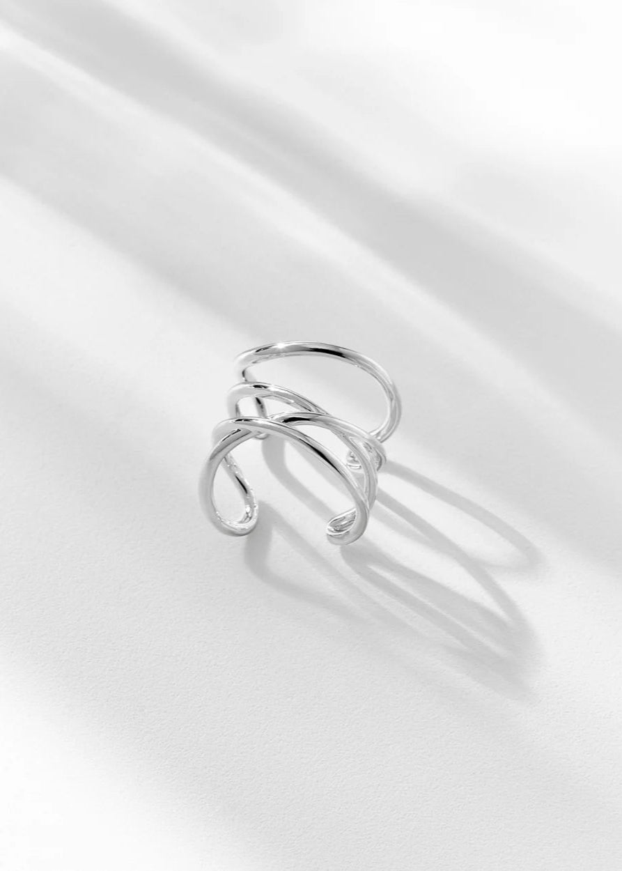 Silver ring on a light gray fabric background