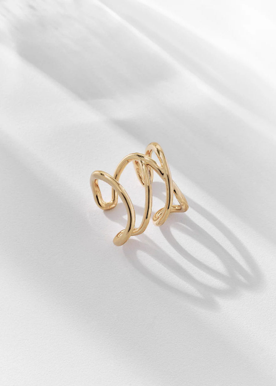Gold ring on a white satin background