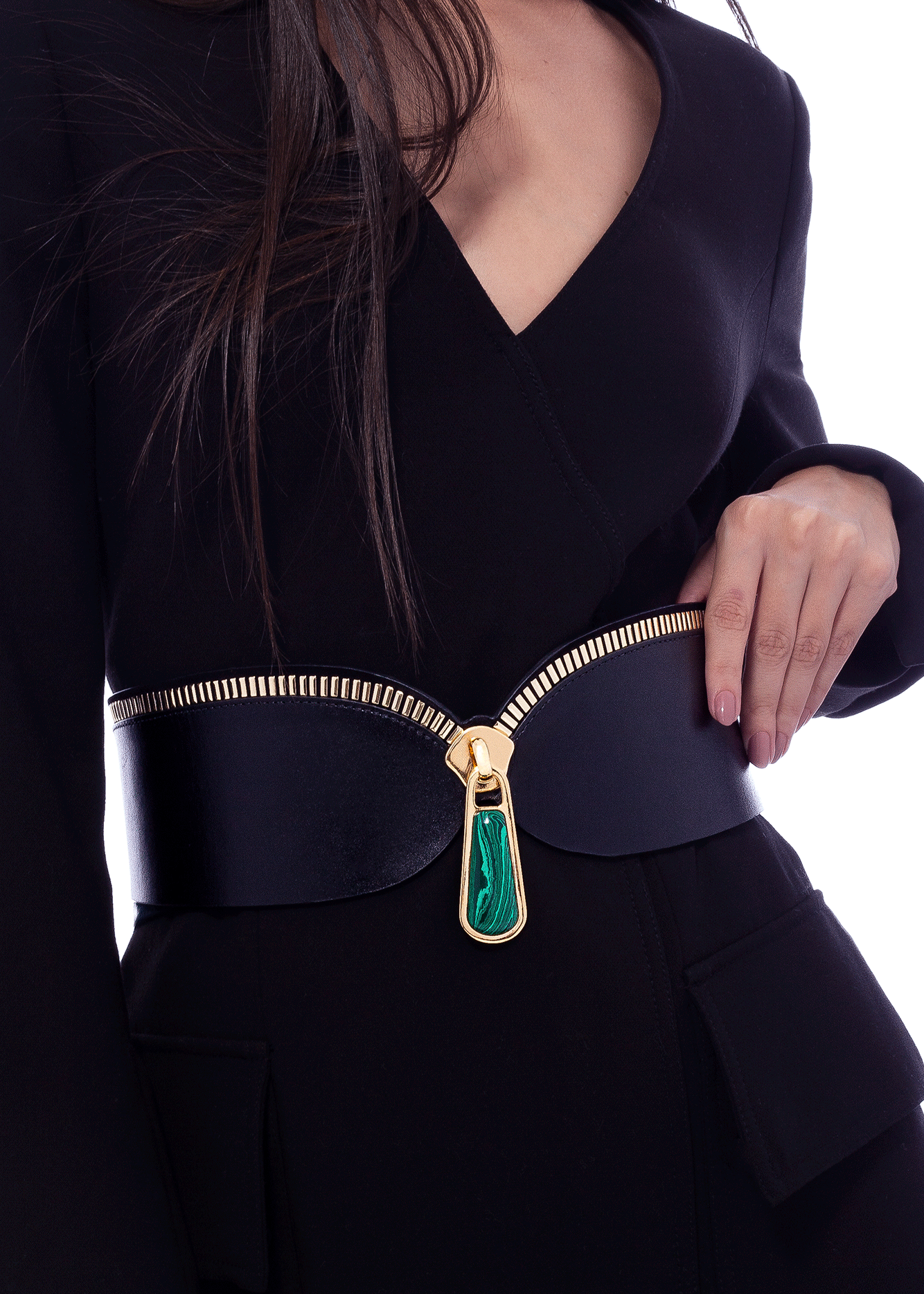 Black outfit with a gold zipper and green gemstone on a white background