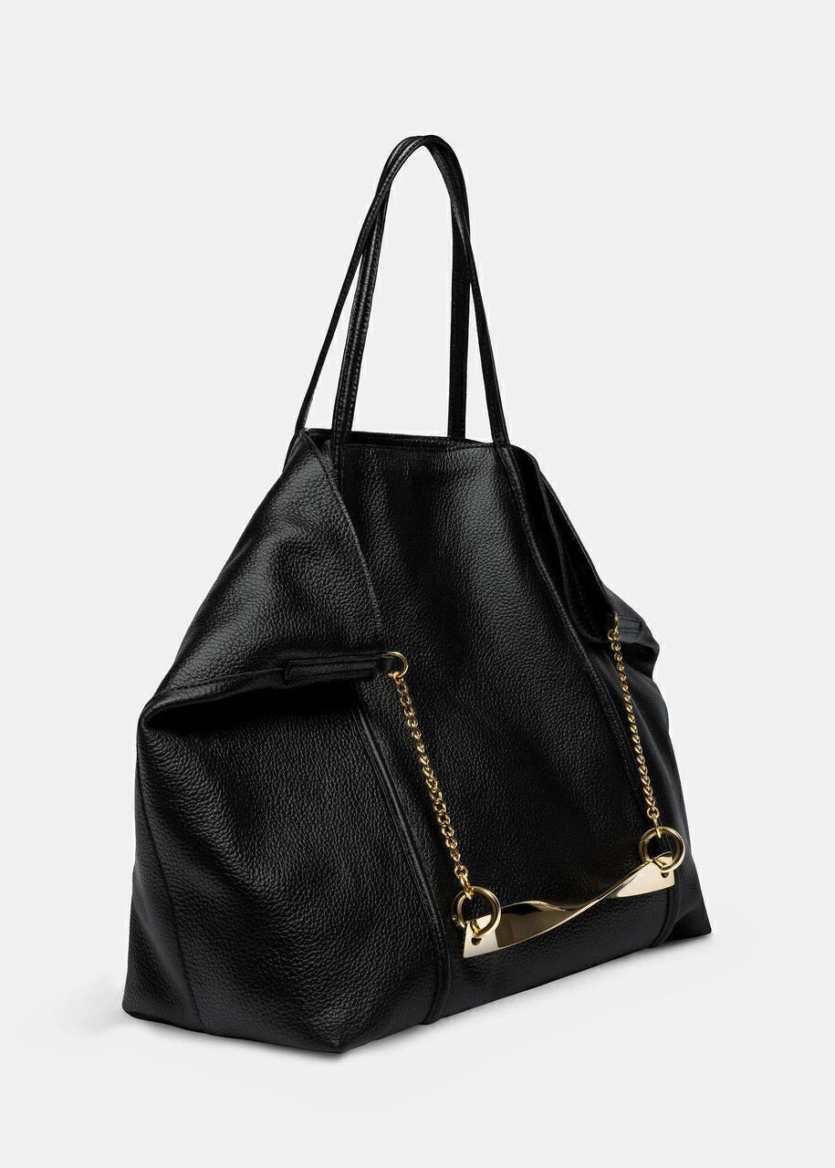 Black leather handbag with gold chain detail on a light gray background