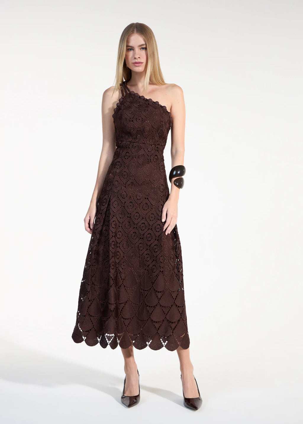 Woman wearing a brown lace dress on a white background