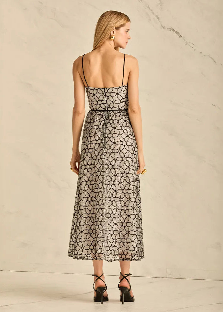 Woman wearing a patterned black and grey dress