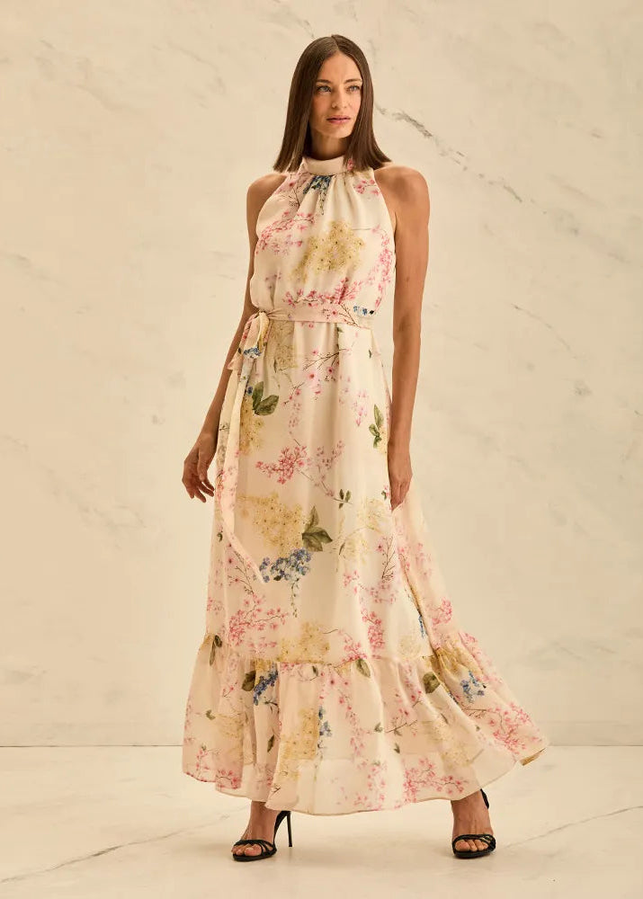 Woman wearing a floral dress against a neutral background