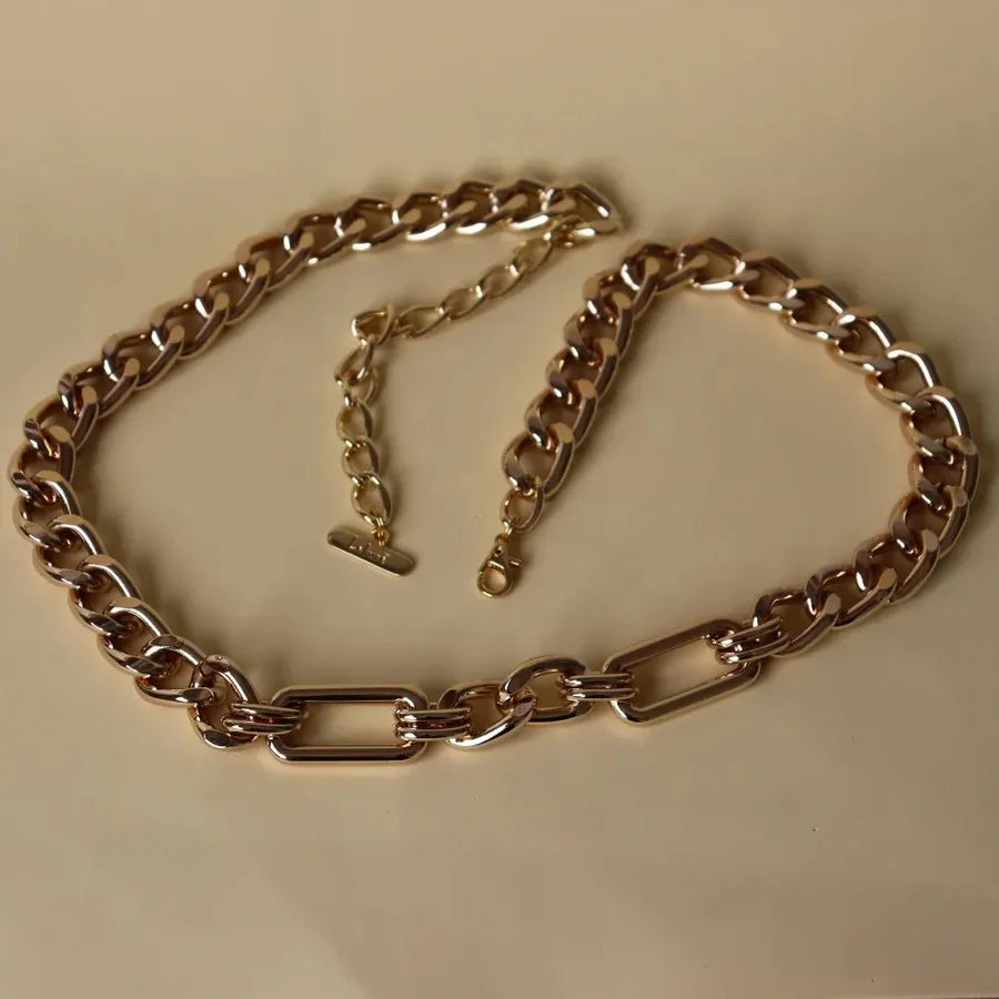 Gold chain belt on a beige background