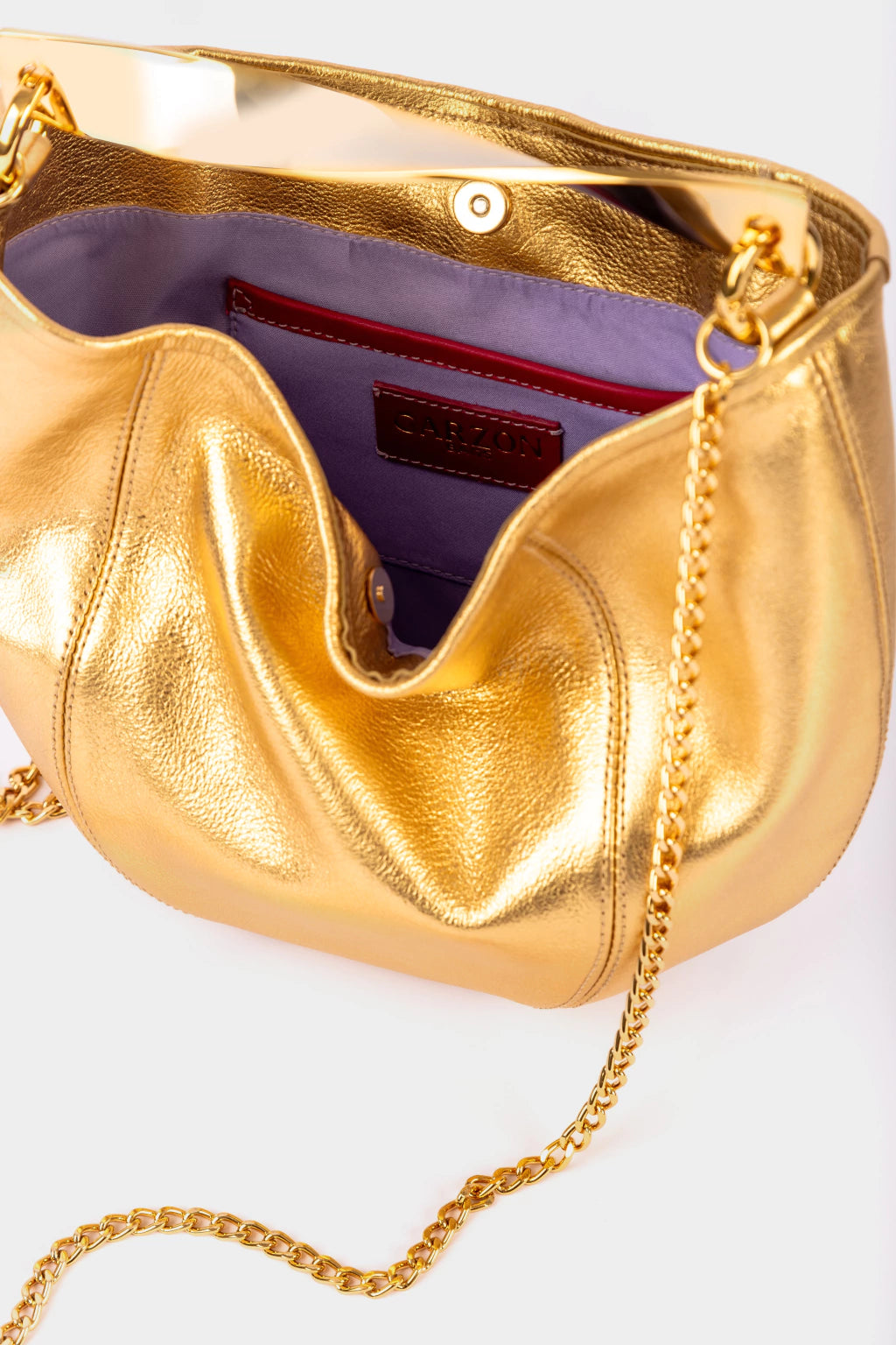 Gold handbag with a chain strap on a white background