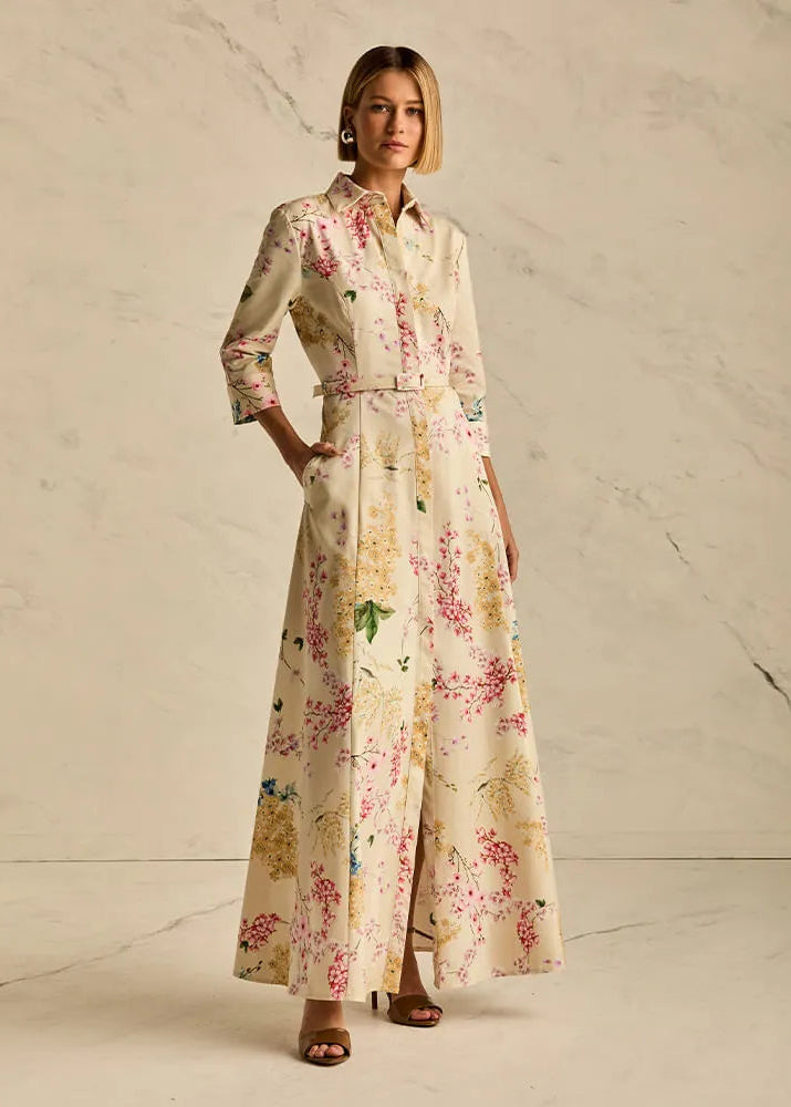 Woman wearing a floral dress against a neutral background