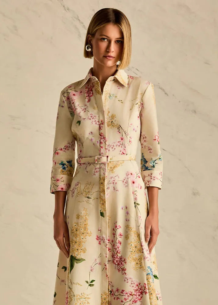 Woman wearing a floral dress against a neutral background