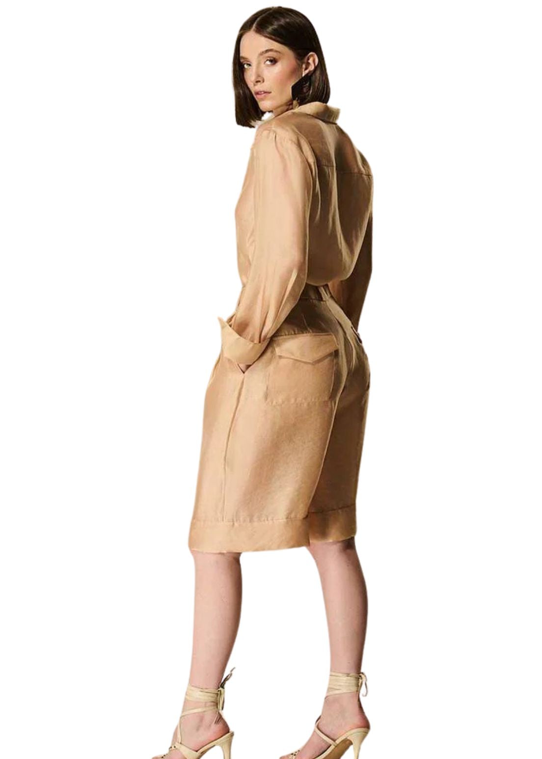 Woman wearing a beige organza shirt on a white background