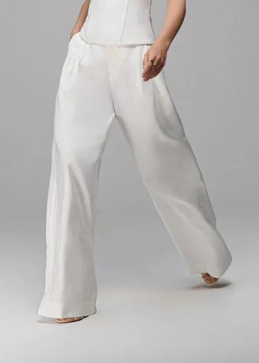 Woman wearing a white outfit on a gray background