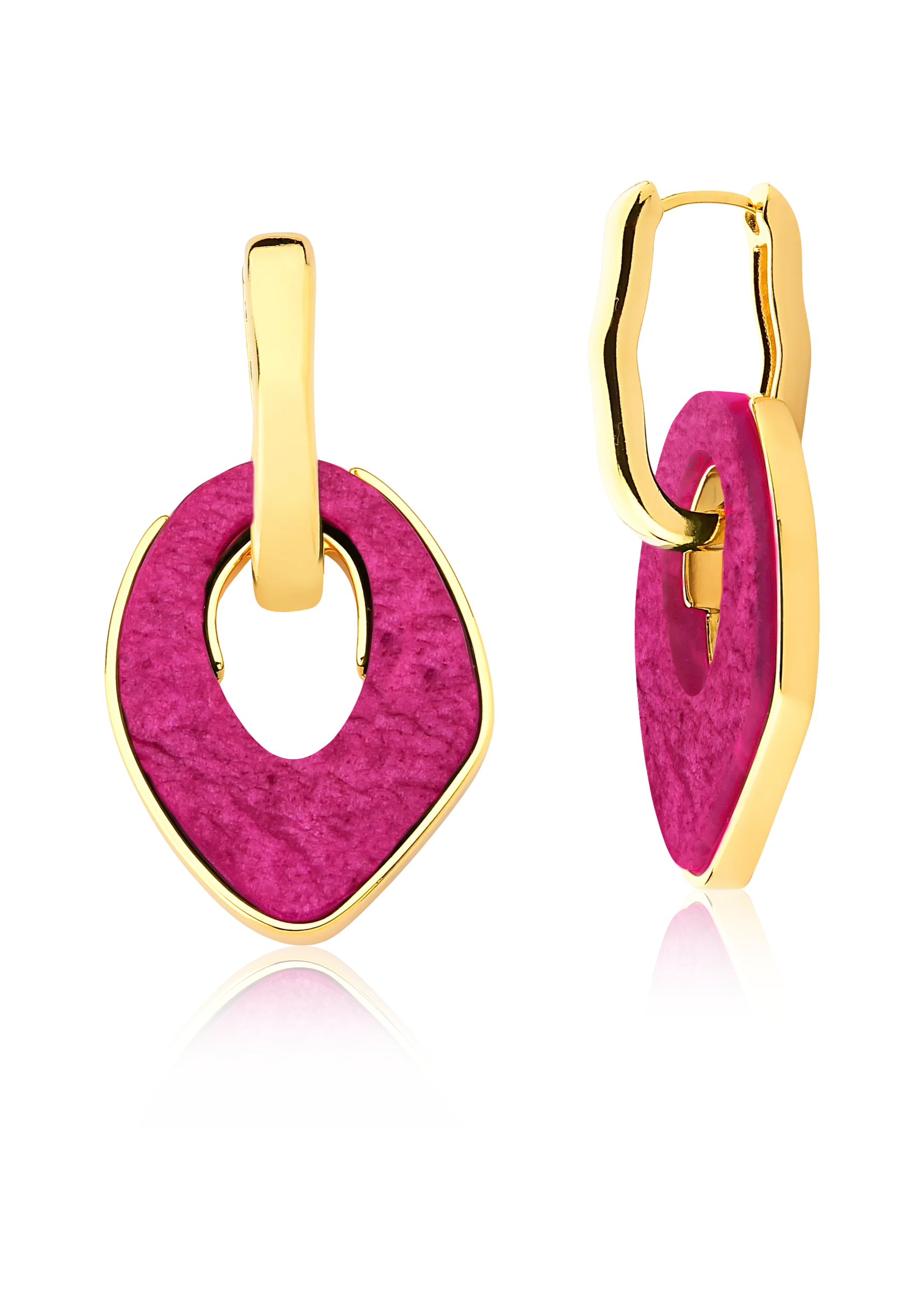 Gold and pink earrings on a white background