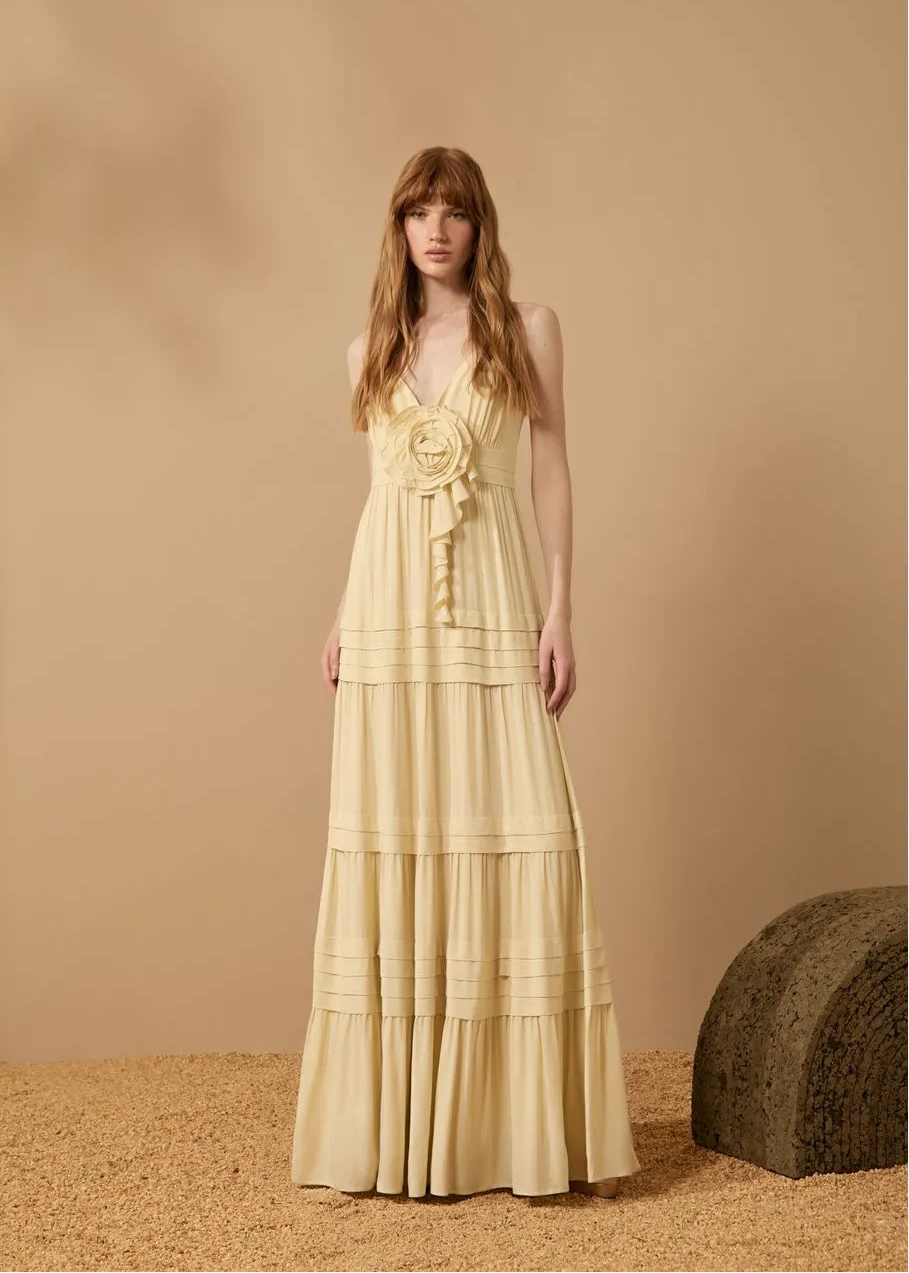 Woman wearing a yellow dress with a beige background